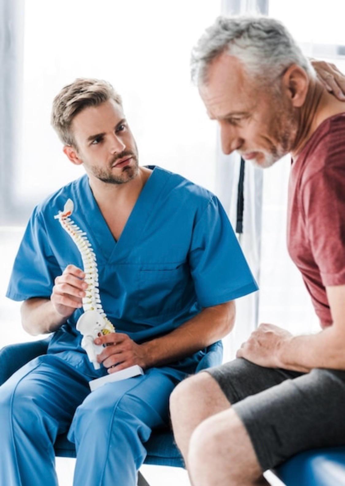 Photo shows Therapist demonstrating postural defects